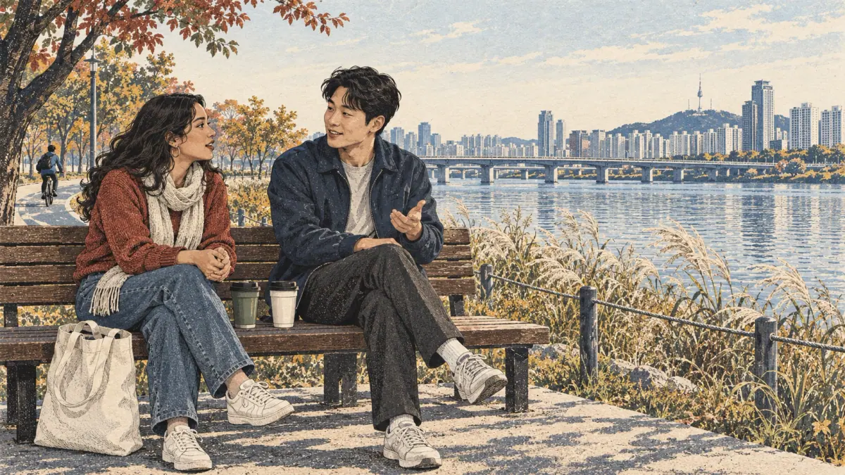 Two adults enjoy a relaxed Korean conversation beside a Seoul riverside path.