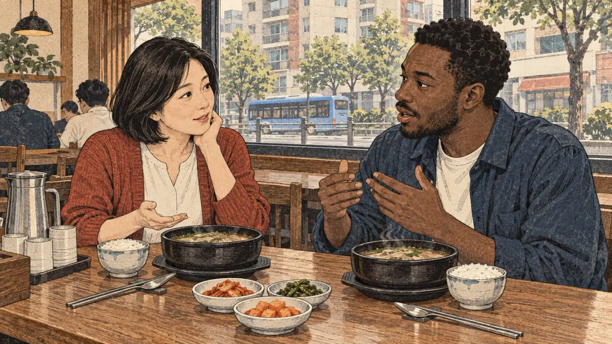 An adult Korean tutor and learner practise pronunciation over soup in a Seoul restaurant.